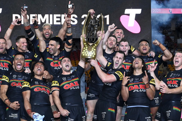 Nathan Cleary (left) and Isaah Yeo lift the premiership trophy at Suncorp Stadium.