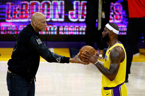 Kareem Abdul-Jabbar joins LeBron James on court.