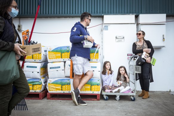 The Jones family, Yvette, Tony and Riley, 7 and Charley, 4, have a sausage outside the Coburg Bunnings after shopping for supplies.