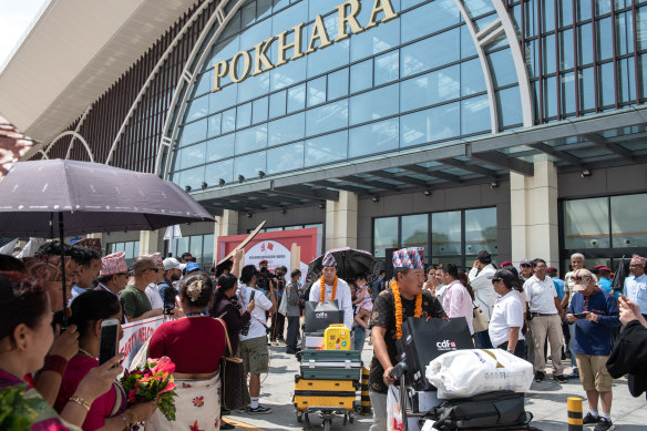 Nepali citizens welcome Chinese passengers from the first international flight to arrive at Pokhara International Airport in Pokhara on June 21, 2023.