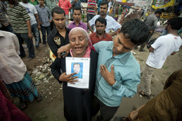 A woman holds a picture of her son, who went missing in the Rana Plaza building collapse, in which at least 1132 people died.