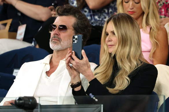 Doyle Bramhall and Elle Macpherson look on at Rod Laver Arena.