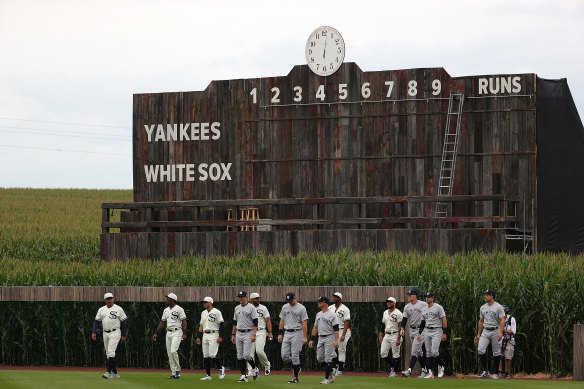 The Chicago White Sox and New York Yankees emerge from the cornfields for the Field of Dreams baseball game in Iowa.