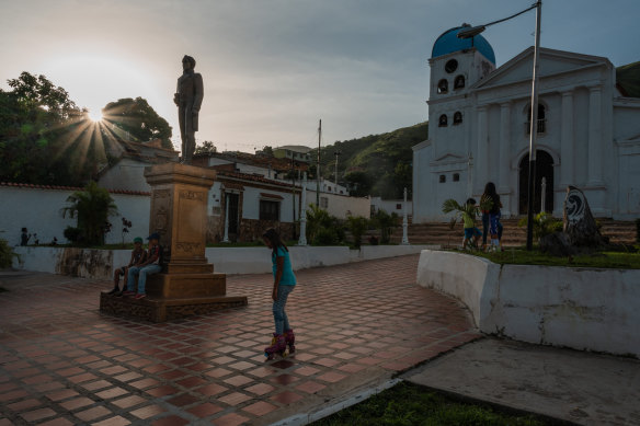 Children play near a church in Sabaneta, Venezuela. Dismantling gangs has reduced theft and kidnapping threats against Ron Santa Teresa’s property and employees, Alberto Vollmer said. 