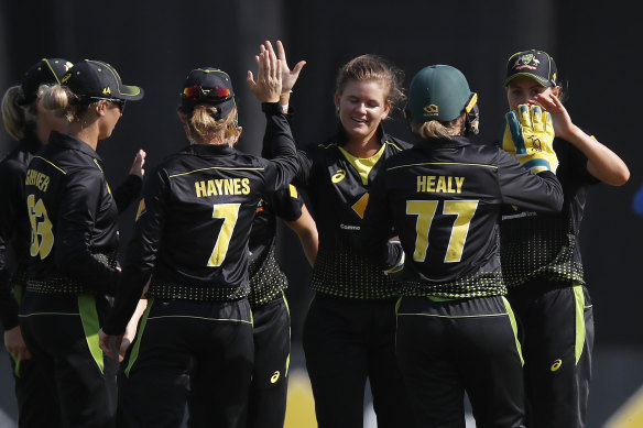 Jess Jonassen, centre, celebrates with Australian teammates after claiming her fifth wicket. 