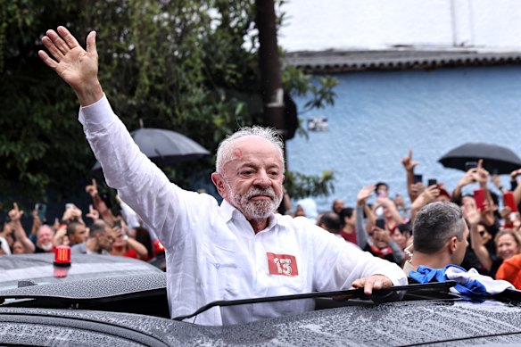 Luiz Inácio Lula da Silva, incumbent president of Brazil and presidential candidate waves to supporters after casting his vote during general election day in Sao Paulo, on Sunday.