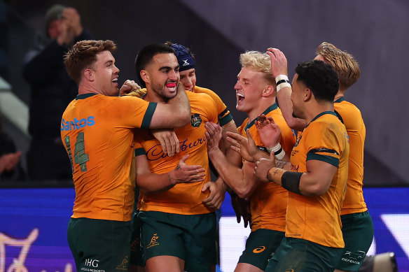 Tom Wright celebrates after scoring against Wales.