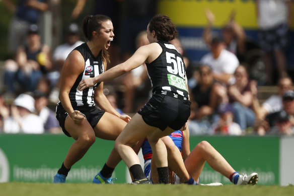 Chloe Molloy celebrates after scoring for the Pies.