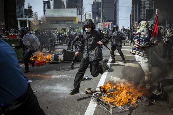 A protester runs through the chaos on Clarendon Street on Wednesday.