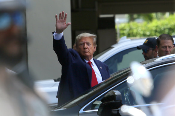 Former U.S. President Donald Trump waves as he makes a visit to a Cuban restaurant after his arraignment.