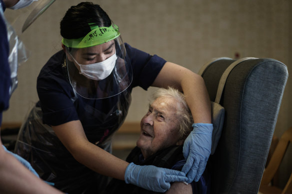 A resident at one of Attendo's nursing homes in Gothenburg receives her first dose of the Pfizer-BioNtech COVID-19 vaccine on Thursday. 
