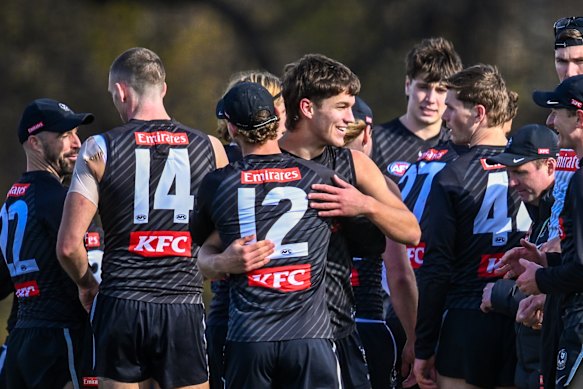 Collingwood teammates congratulate Charlie West at training on Tuesday ahead of his debut.