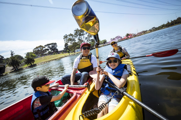 One less can in the river: The Wong family has a ball picking litter out of the Maribyrnong River.