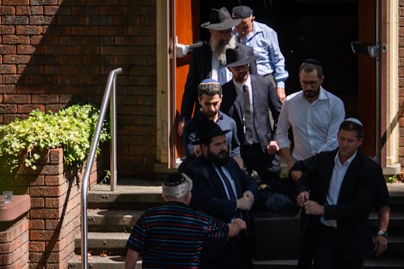 Mourners help carry the coffins of Boris and Sofia Gurman after a funeral service at Sydney Chevra Kadisha memorial hall.