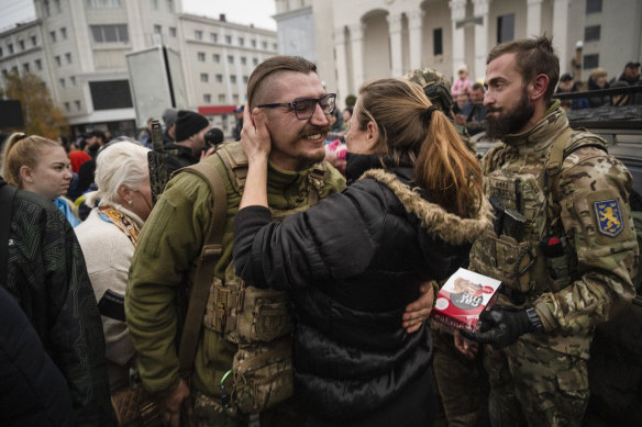 Ukrainian civilians and soldiers rejoice over the liberation of Kherson.