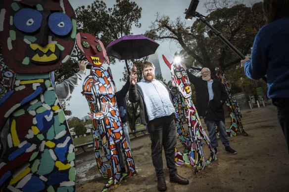 Warrnambool artist Matthew Clarke is lit up by his father Andrew (right), with his Rising Festival work, Wallabies. 