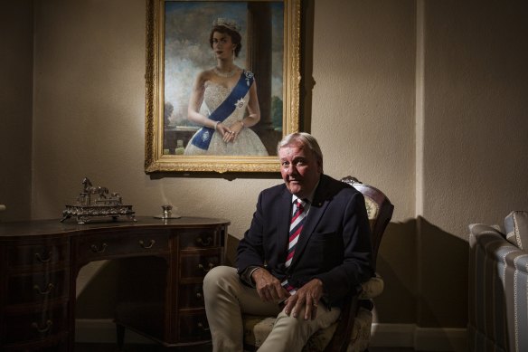 Constitutional monarchist Jason Ronald at home with a portrait of the Queen.