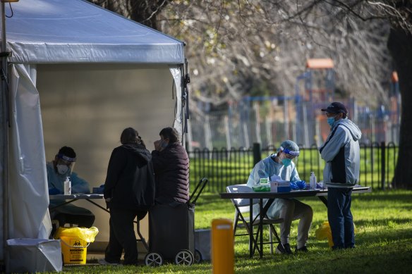 Residents from the Racecourse Road public housing towers line up for testing on Sunday morning.