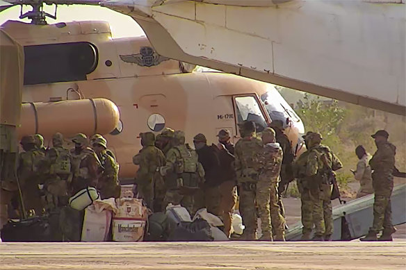 Russian mercenaries board a helicopter in northern Mali. 