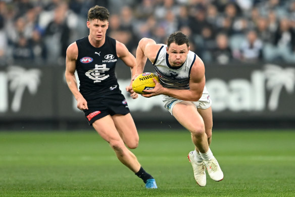 Patrick Dangerfield, right, gathers the ball in front of Sam Walsh.