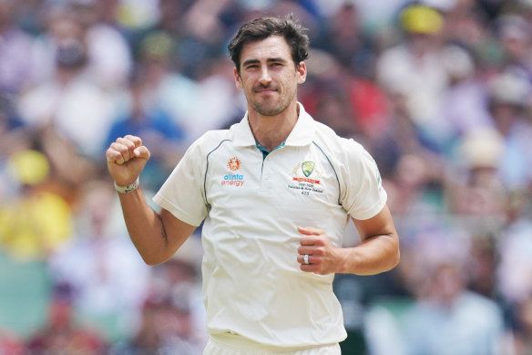 Mitchell Starc celebrates taking a wicket. 