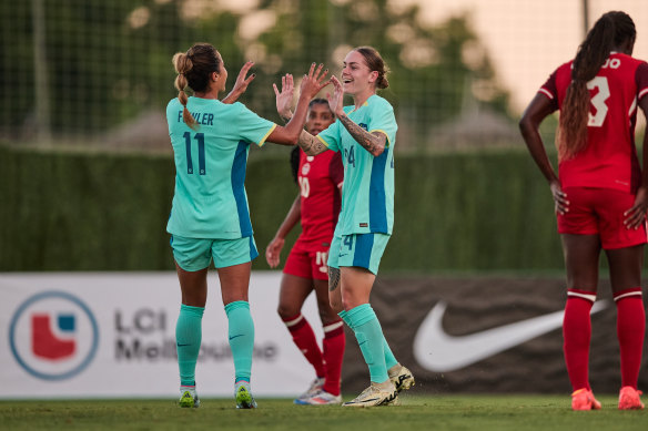 Sharn Freier celebrates with Mary Fowler after scoring Australia’s goal against Canada.