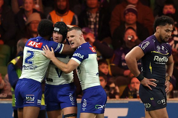 Matt Burton of the Bulldogs celebrates with teammates after scoring a try.