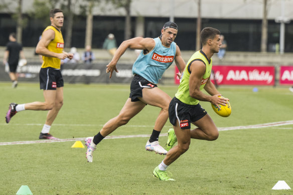 Scott Pendlebury chases Nick Daicos at Collingwood training a fortnight ago.
