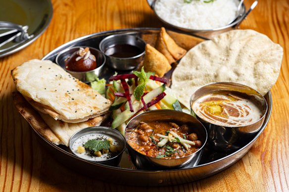 The vegetarian thali includes chole masala, samosa, rice and dessert. 