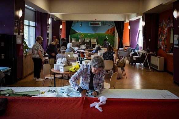 Amparo Collazos cutting fabric during the weekly sewing class she set up. It’s one of the many activities available to the tower’s elderly residents that provides them with a sense of community.