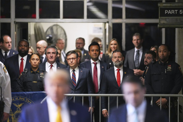 From left, North Dakota Governor Doug Burgum, US Speaker of the House Mike Johnson, businessman Vivek Ramaswamy and Florida congressman Byron Donalds look on as former President Donald Trump talks to the media.