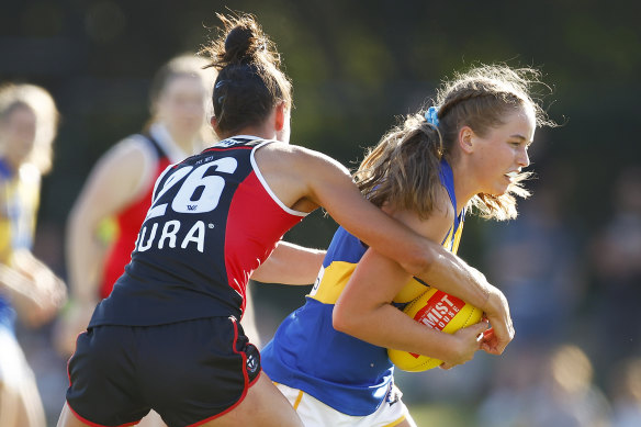 Charlotte Thomas of the Eagles is tackled by St Kilda’s Leah Cutting.