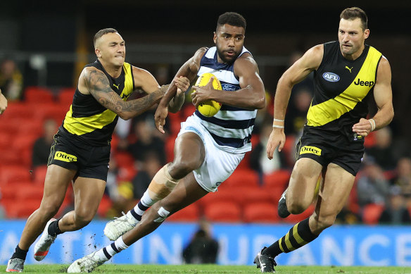 Geelong's Esava Ratugolea, who kicked two goals, breaks free of a tackle by Shai Bolton. 