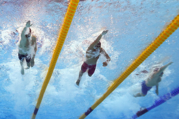 Brooks Curry of Team United States and Kyle Chalmers of Team Australia compete in the 4x100m Mixed Relay Final.