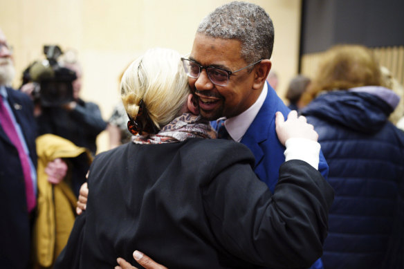 Vaughan Gething is congratulated by Labour supporters in a lecture hall at Cardiff University.