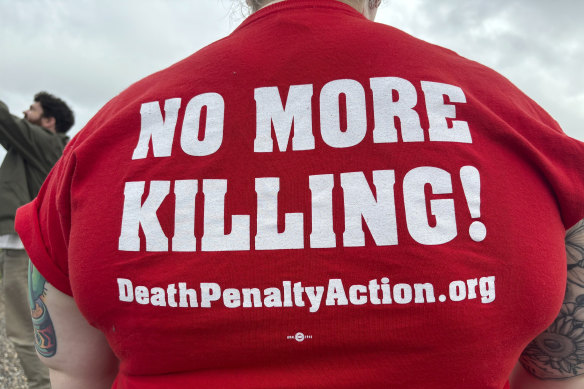 Anti-death penalty activists place signs along the road heading to Holman Correctional Facility in Atmore, Alabama, ahead of the scheduled execution of Kenneth Eugene Smith.
