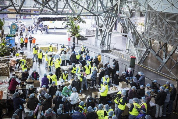 Volunteers busy at work in the Atrium at Federation Square.