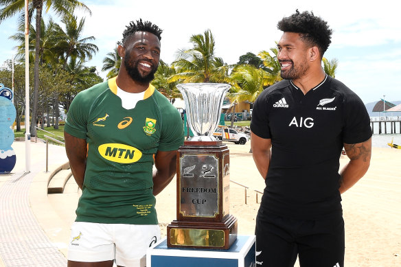 Siya Kolisi of the Springboks and Ardie Savea of the All Blacks speak as they pose with the Freedom Cup trophy.