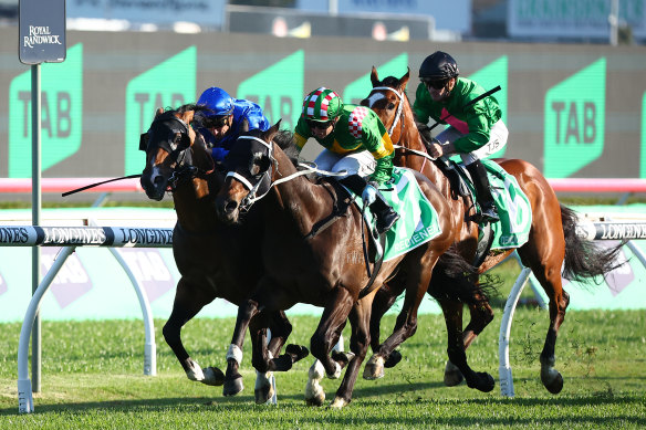 Kathy O’Hara charges to the front on Rediener in the Epsom.