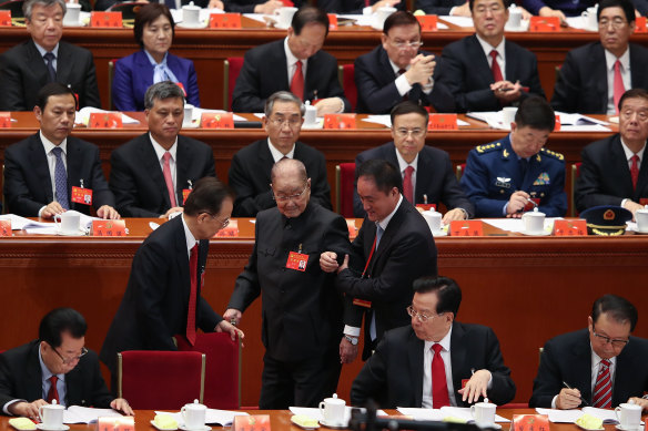 Song Ping, now 105, is ushered to his chair at the start of the Communist Party’s National Congress in Beijing in 2017.
