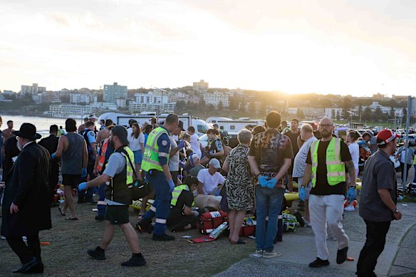 Paramedics help one of the gunmen's victims.