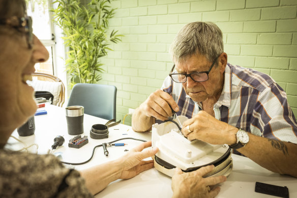 Linda Weiss from Beaumaris gets her sandwich press fixed by David Williams.