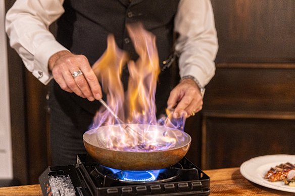 Armagnac, shiraz, shallots, thyme, master duck stock, duck livers and butter is added, before the sauce is flambéed tableside.