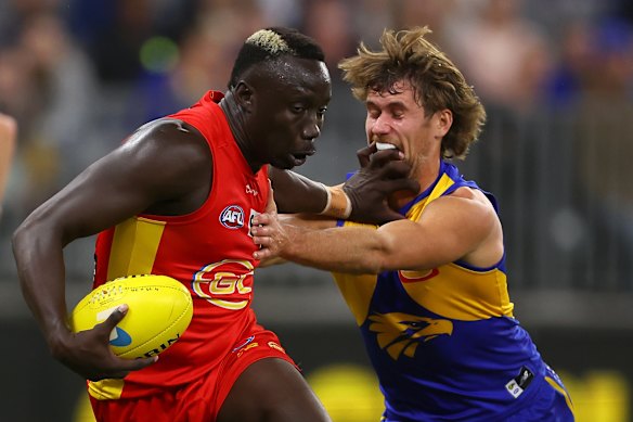 Mabior Chol of the Suns fends off Connor West of the Eagles.