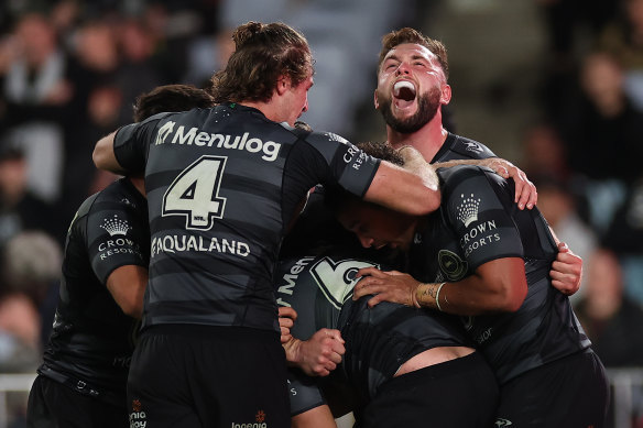 The Rabbitohs celebrate victory on Thursday night.