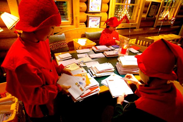 Santa’s helpers sort through letters at the main post office in Lapland, Finland. Each year over 600,000 to 700,000 letters arrive there for Santa.