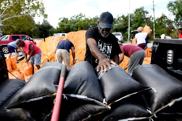 Residents pick up sandbags for storm preparation ahead of Hurricane Isaias’ expected landfall.