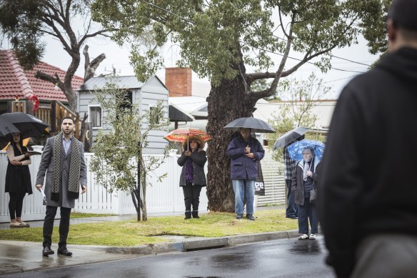 Buyers kept their hands in their pockets, or on their umbrellas, and did not bid at the auction.