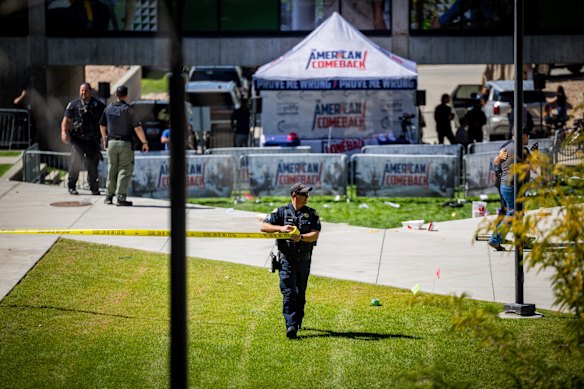 A police officer tapes off an area after the shooting.