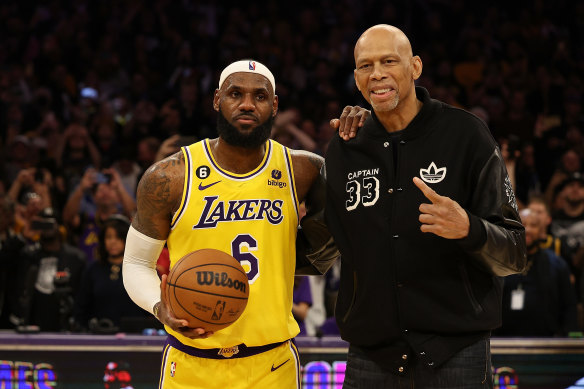 Kareem Abdul-Jabbar joins LeBron James on court.